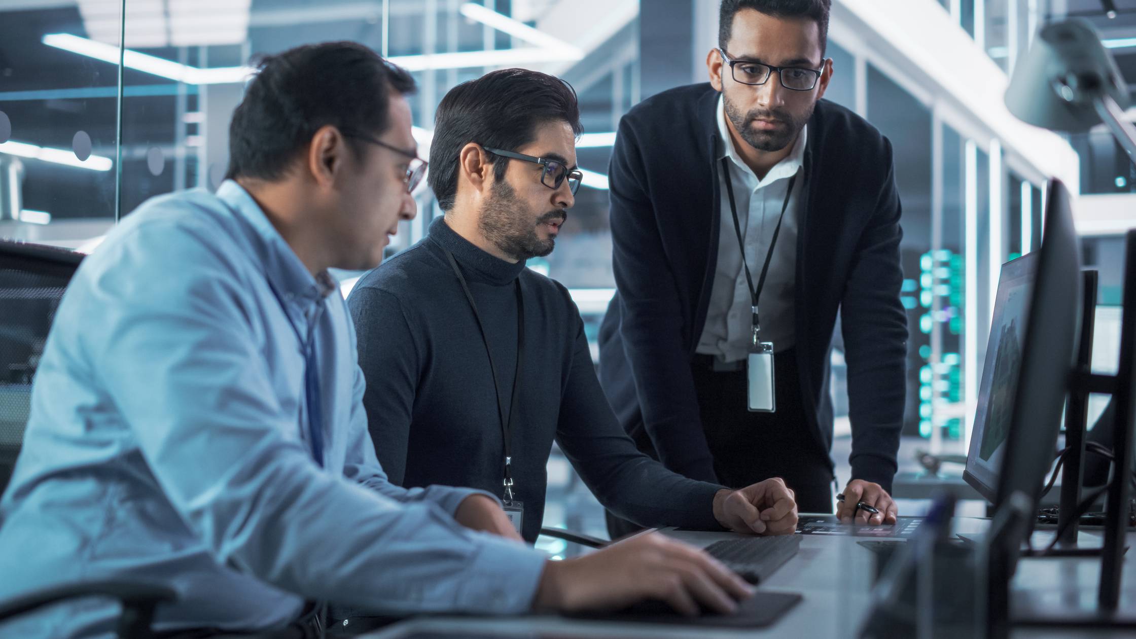 Engineers use computer to discuss a technological project in industry 4.0 modern factory office